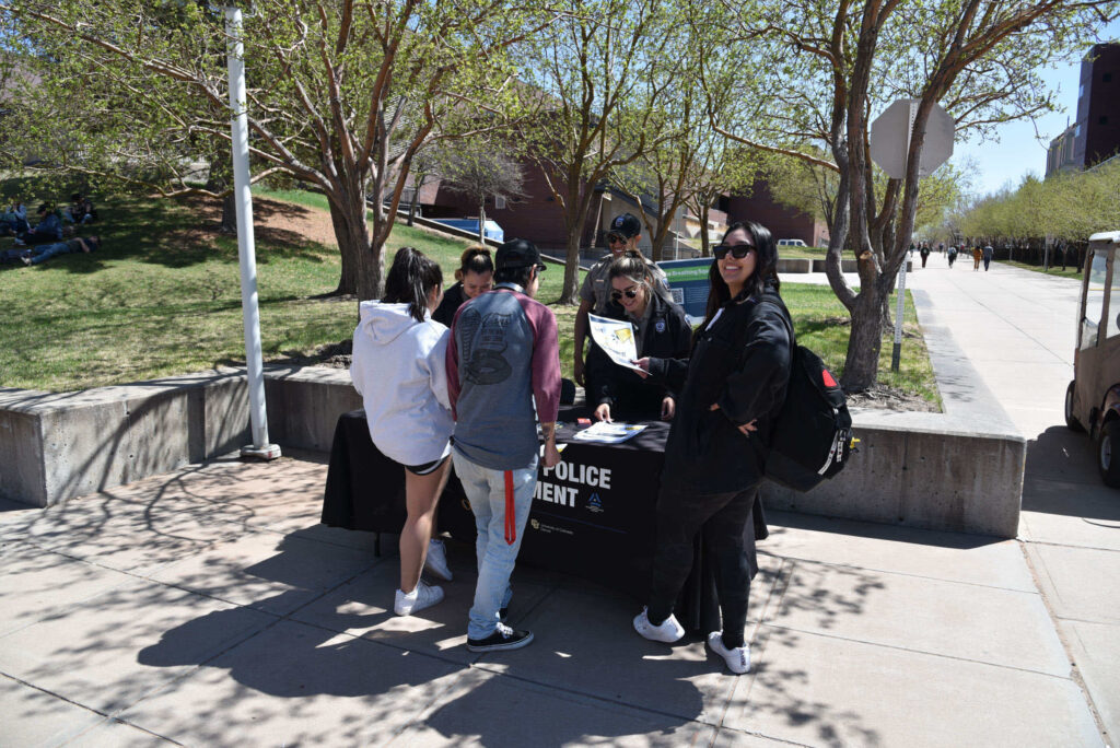 Campus Safety - Auraria Police Department members at a stand on campus talking to students