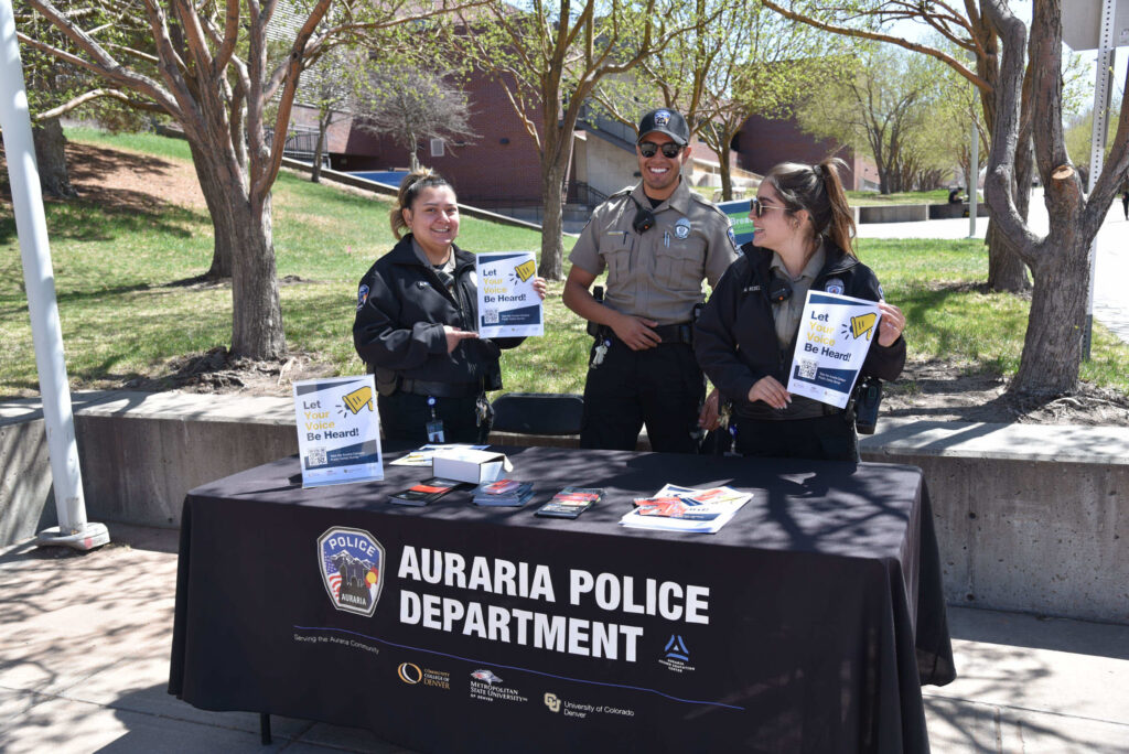 Campus Safety - Auraria Police Department members at a stand on campus handing out pamphlets