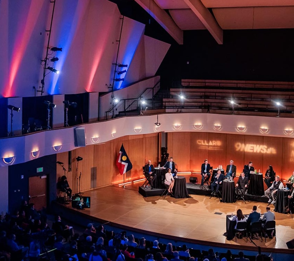 Balcony view of mayoral debate taking place on stage at King Center